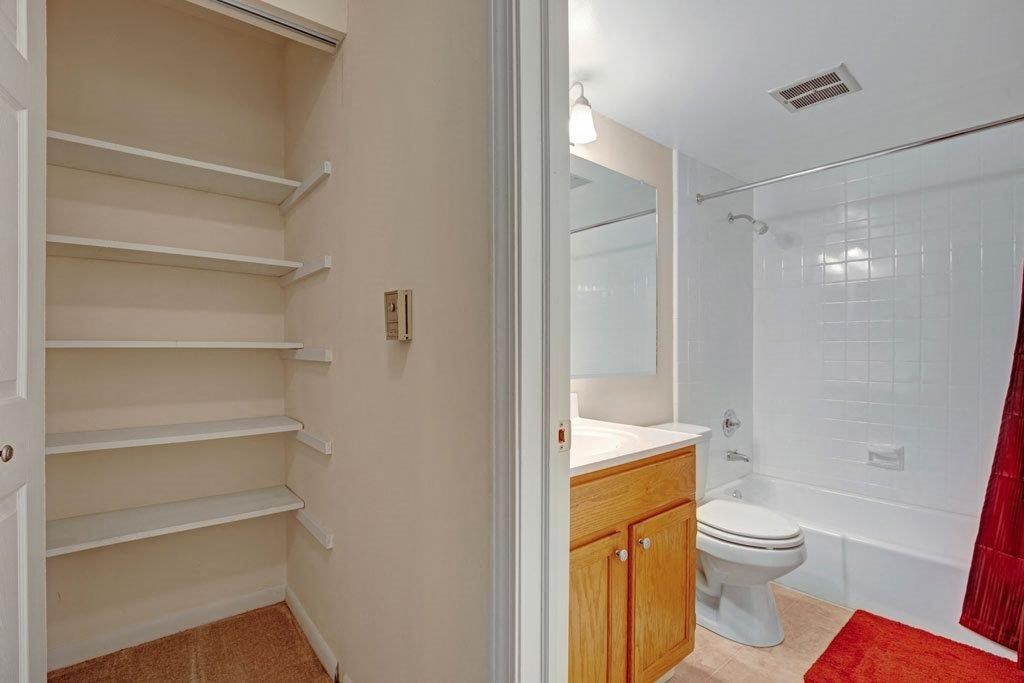 a bathroom with a toilet and a sink and a shower