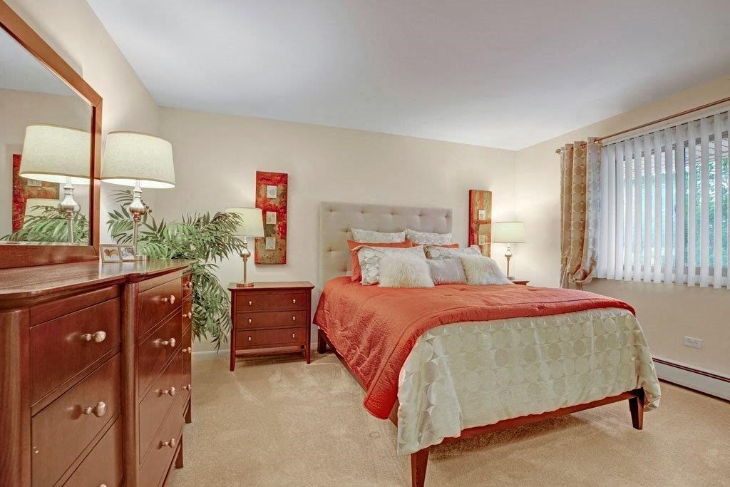 a bedroom with a bed and a dresser