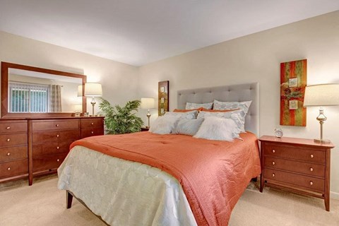 a bedroom with a bed and a mirror