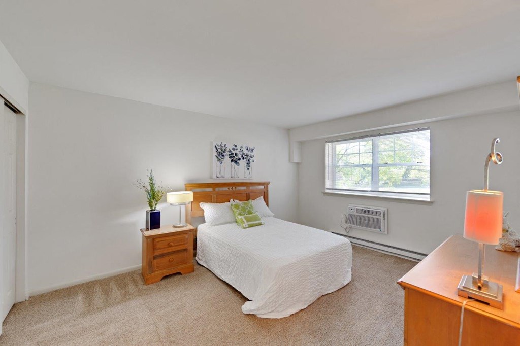 a bedroom with a bed and a window