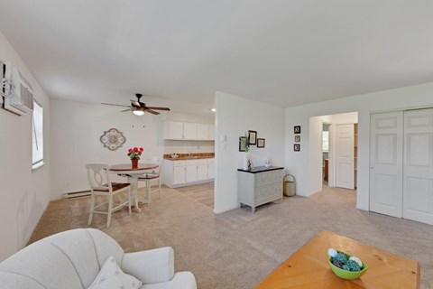 A living room with a white couch and a wooden table.