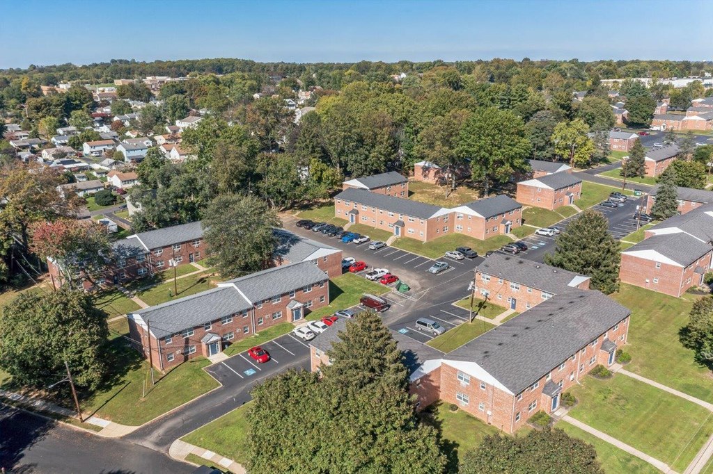 an aerial view of a campus with brick buildings and trees