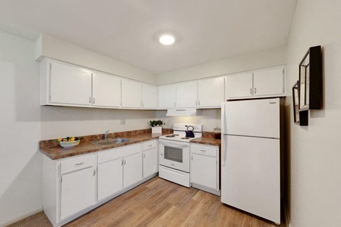 a white kitchen with white appliances and white cabinets