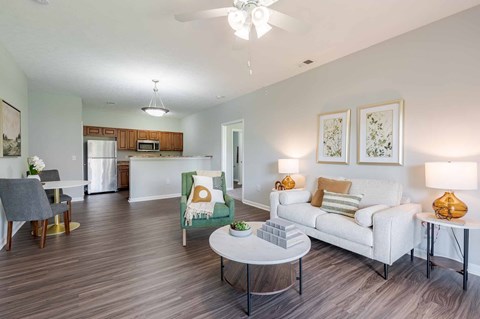 A living room with a white couch and a grey chair.