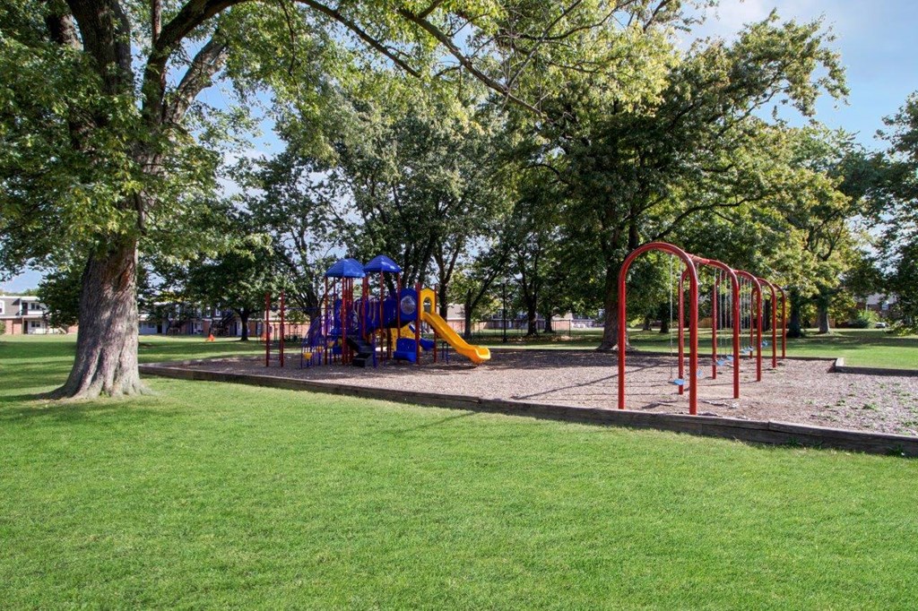 a group of letters in the grass with trees in the background
