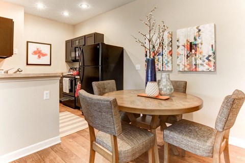 A dining room with a table and chairs.