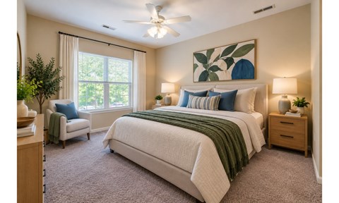 A bedroom with a large bed and a ceiling fan.