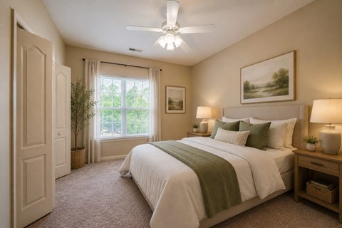 A bedroom with a large bed and a ceiling fan.