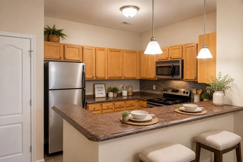 A kitchen with wooden cabinets and a granite countertop.