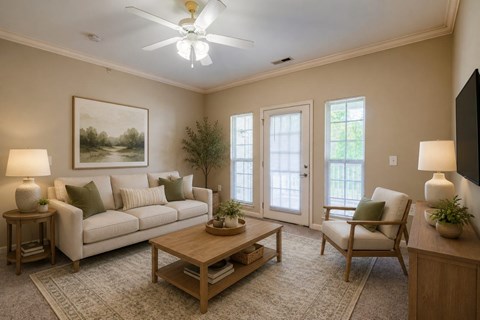 A living room with a couch, a chair, a coffee table, and a painting on the wall.