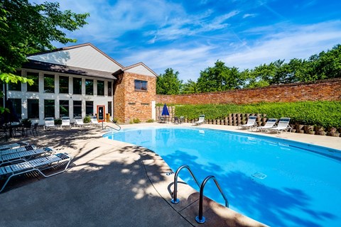 A pool with a building behind it.