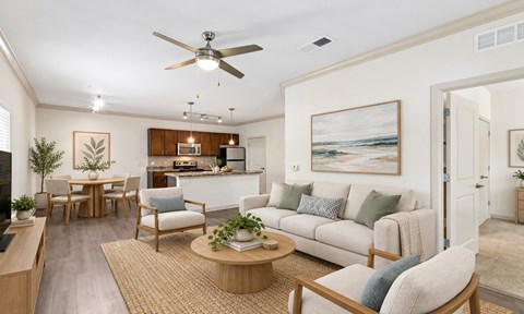 A living room with a couch, chairs, and a ceiling fan.