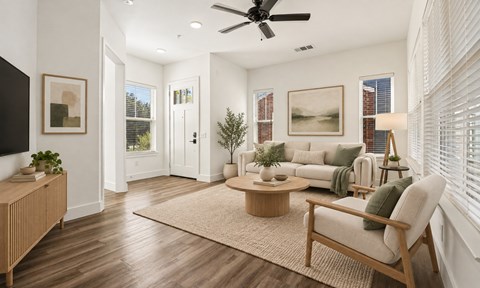 A living room with a wooden floor and furniture.