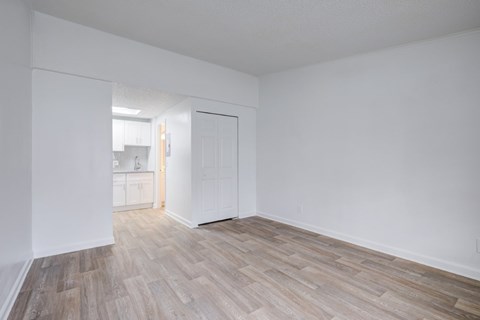A room with a wooden floor and white walls.