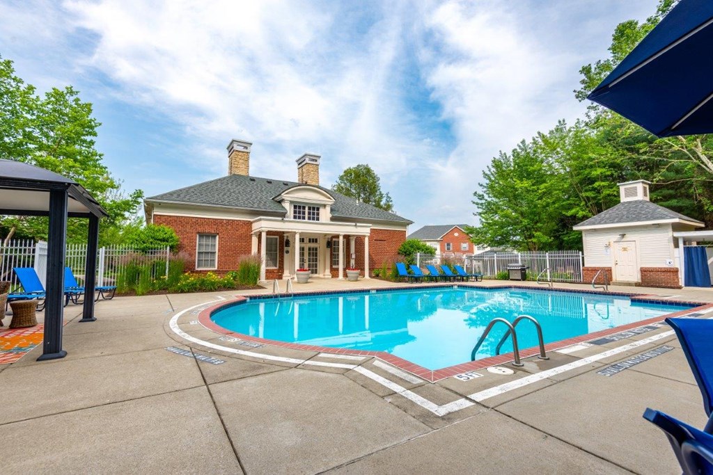 a swimming pool with a house in the background