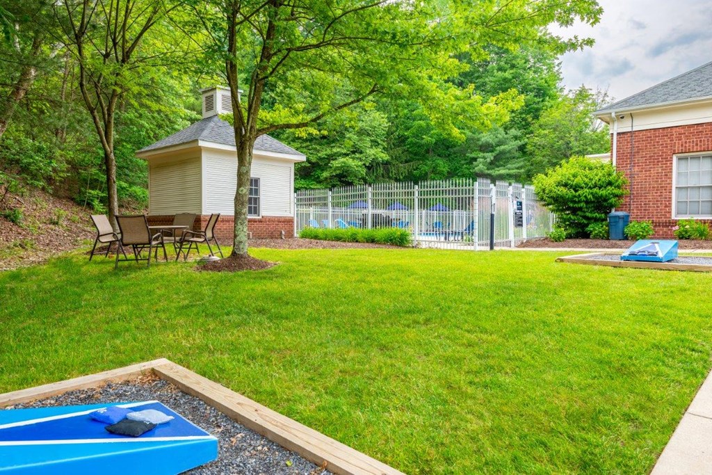 a backyard with a ping pong table and a pool