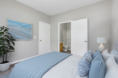 a bedroom with a bed and a bathroom with a toilet