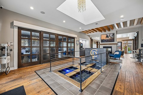 A modern living room with a pool table in the center.