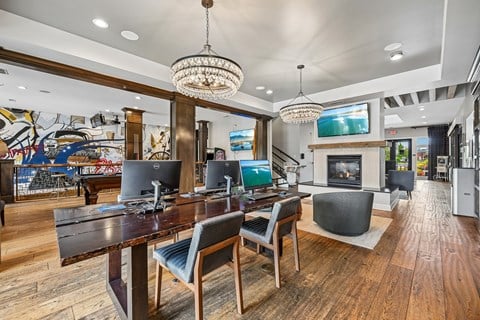A modern dining room with a wooden table and chairs.