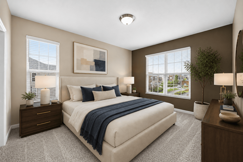 A bedroom with a large bed, a nightstand with a lamp, and a window with blinds.
