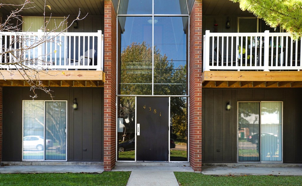 A modern house with a black door and a glass window.