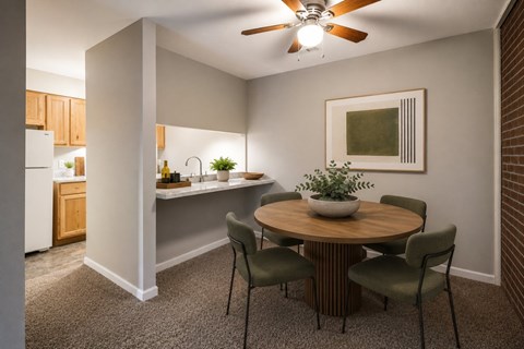 A dining room with a round table and chairs.