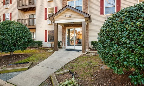 the walkway to the front entrance of an apartment building