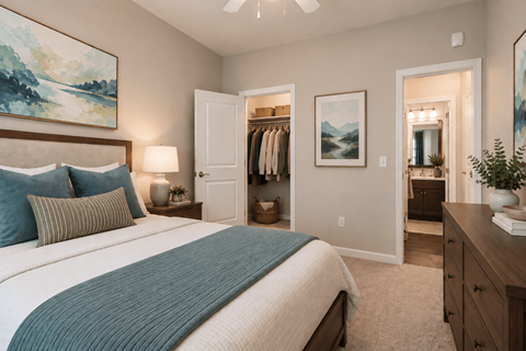 A bedroom with a large bed and a painting on the wall.