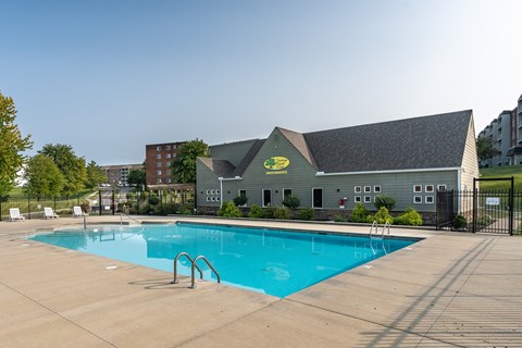A pool with a building behind it.