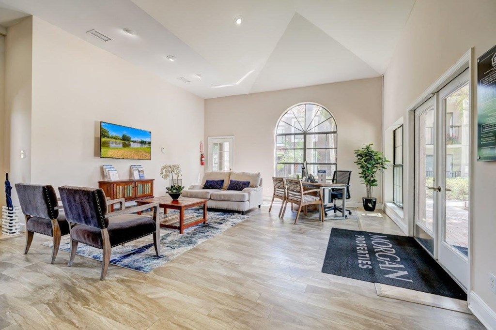 a living room with a couch chairs and a table