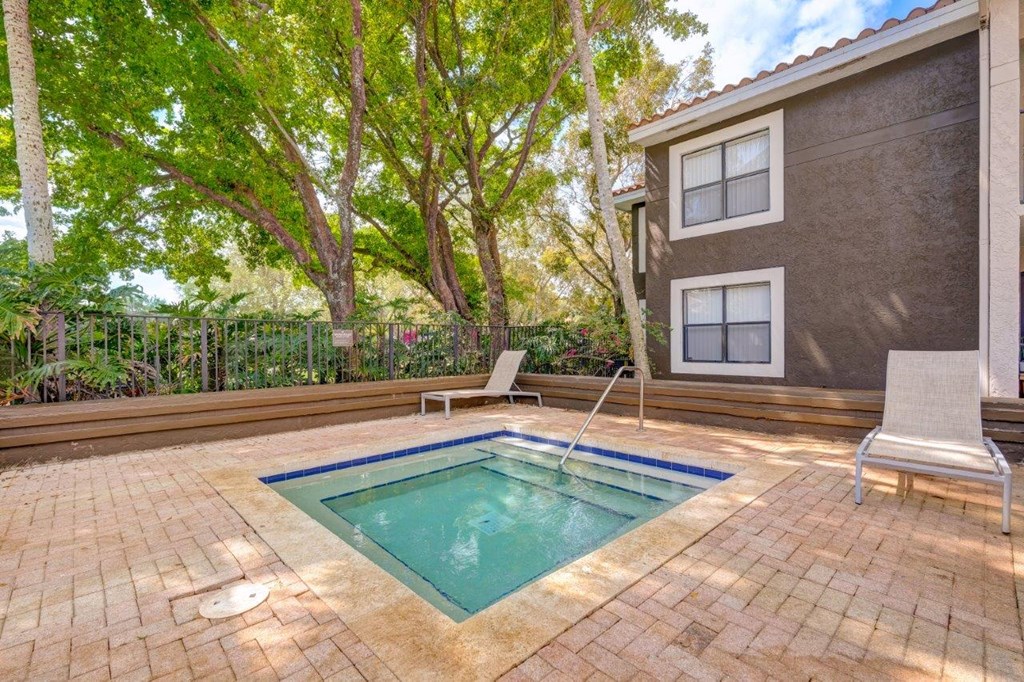 a backyard with a pool and a house in the background
