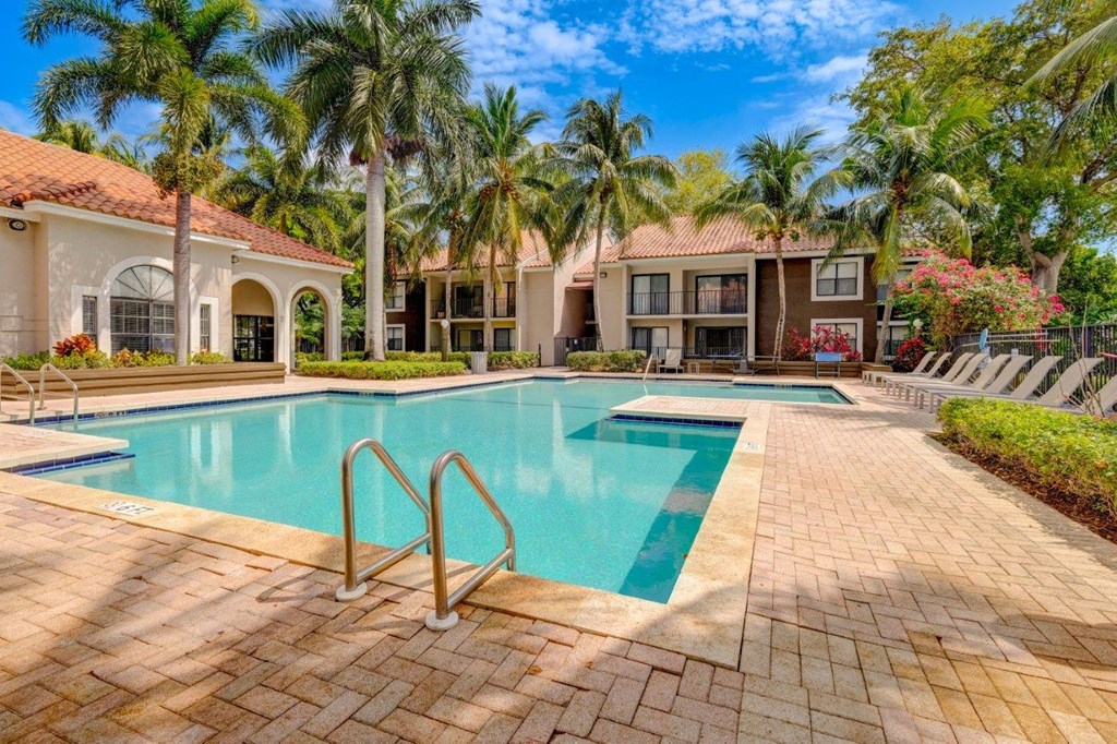 a swimming pool with palm trees in the background