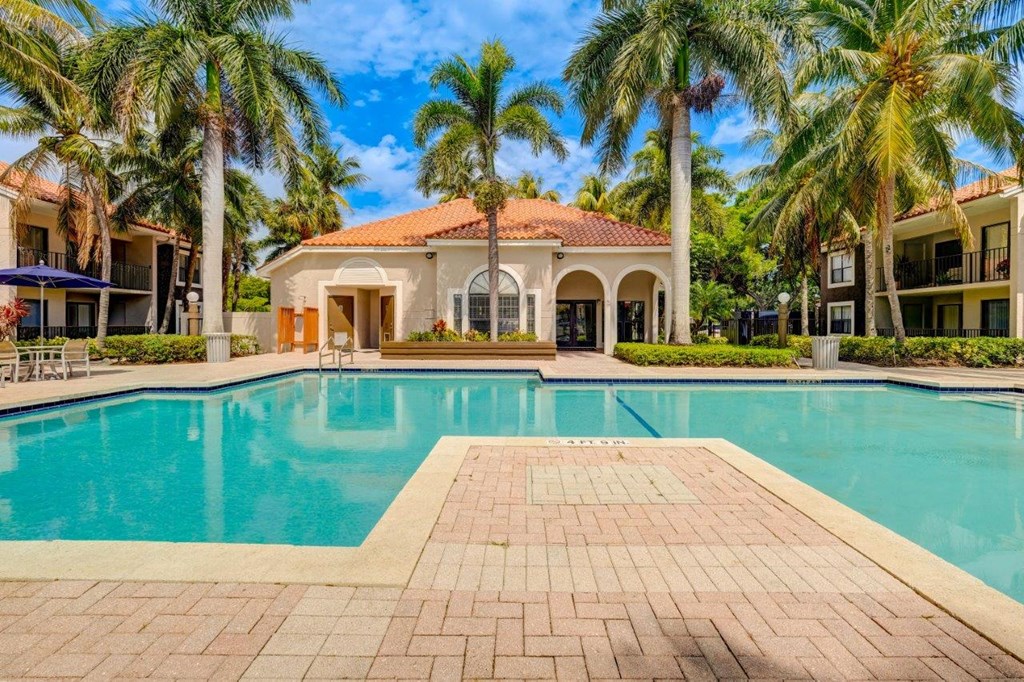 a mansion with a swimming pool in front of it