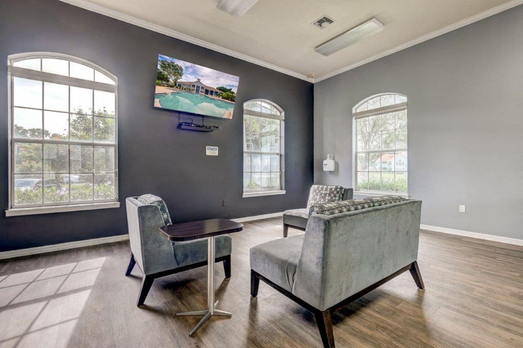 a living room with couches and a tv on the wall
