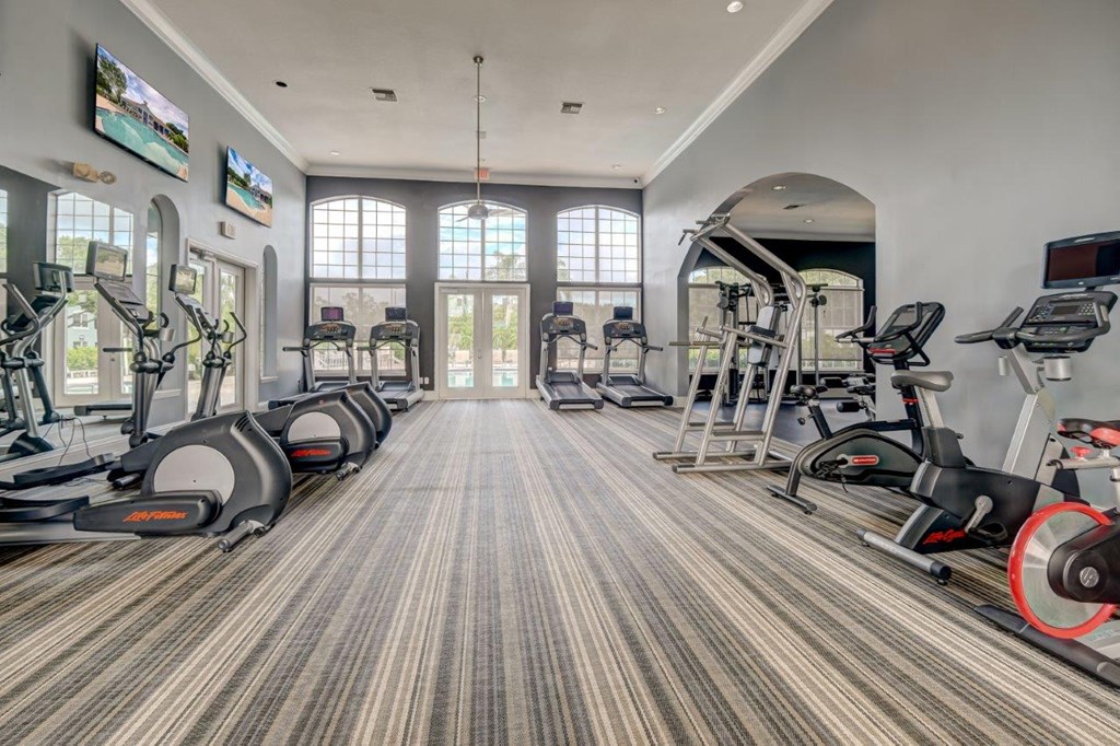 the gym in the clubhouse is equipped with cardio equipment and weights