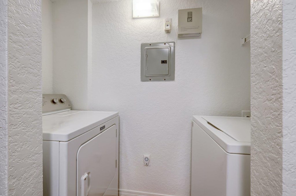 a laundry room with two washes and a dryer