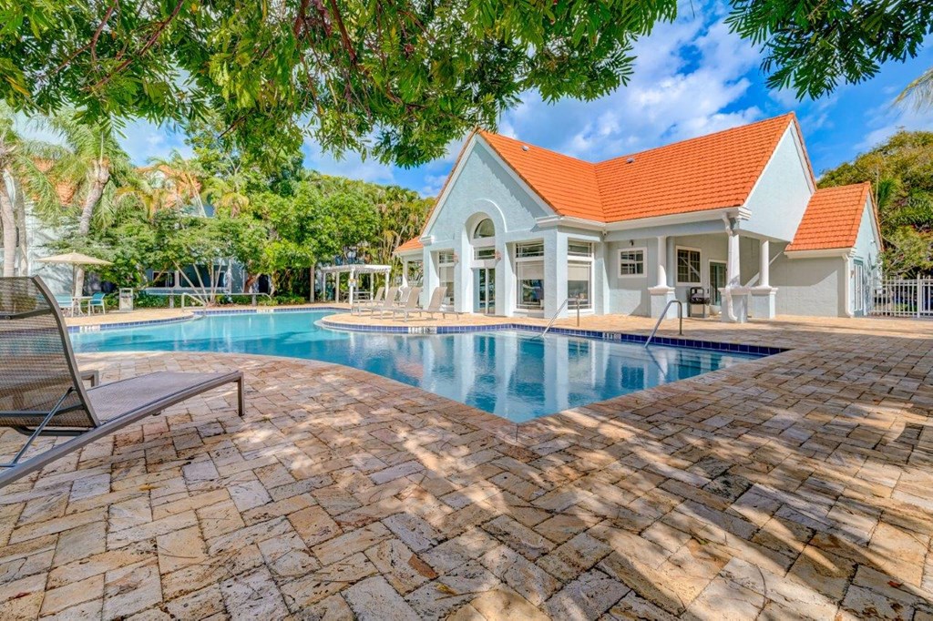 a swimming pool with a house in the background