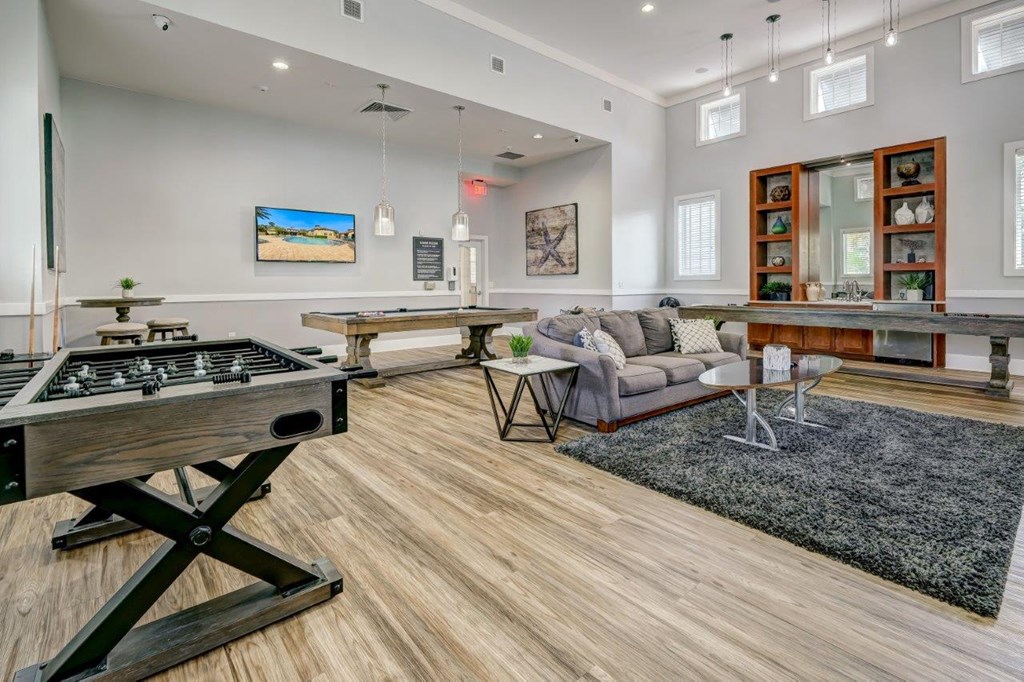a games room with a foosball table and ping pong table