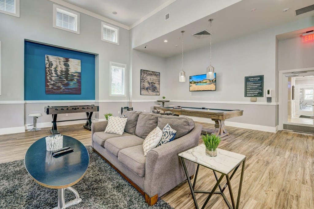 a games room with a shuffleboard and foosball table