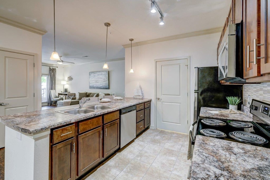 a kitchen with a long counter and a stove top oven