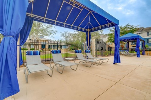 our covered patio has lounge chairs and a gazebo