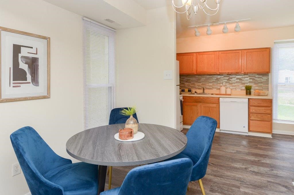 a kitchen and dining room with a table and chairs