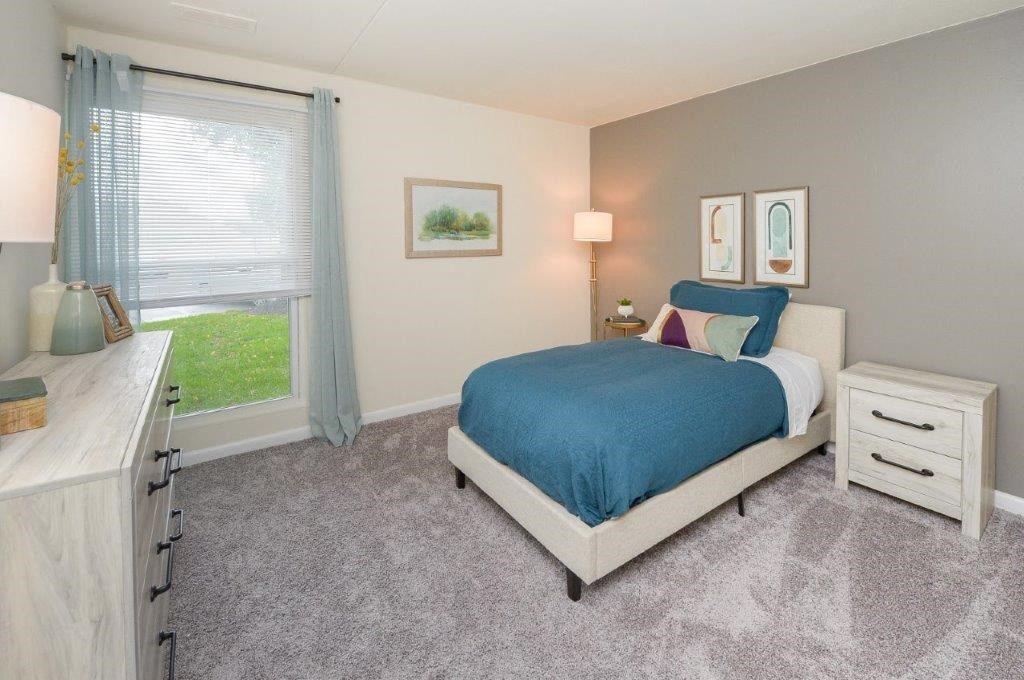 a bedroom with a bed and a window