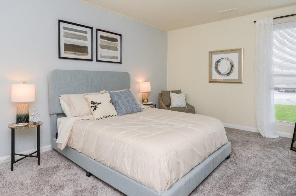 a bedroom with a bed and some pictures on the wall