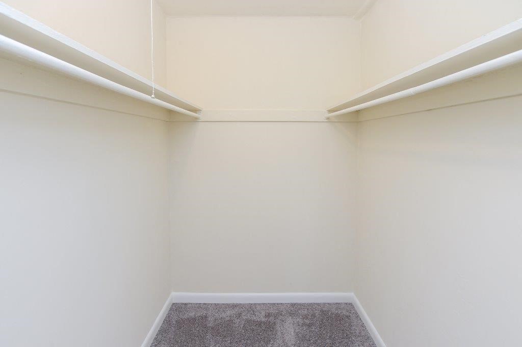 an empty room with white walls and a carpet