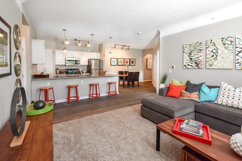 A living room with a grey couch and a coffee table.