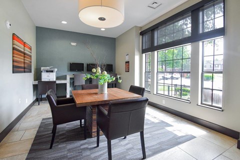 A dining room with a table and chairs.