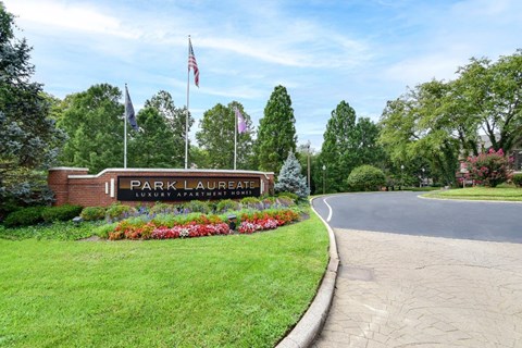 The sign for Park Laurate is on a brick wall.