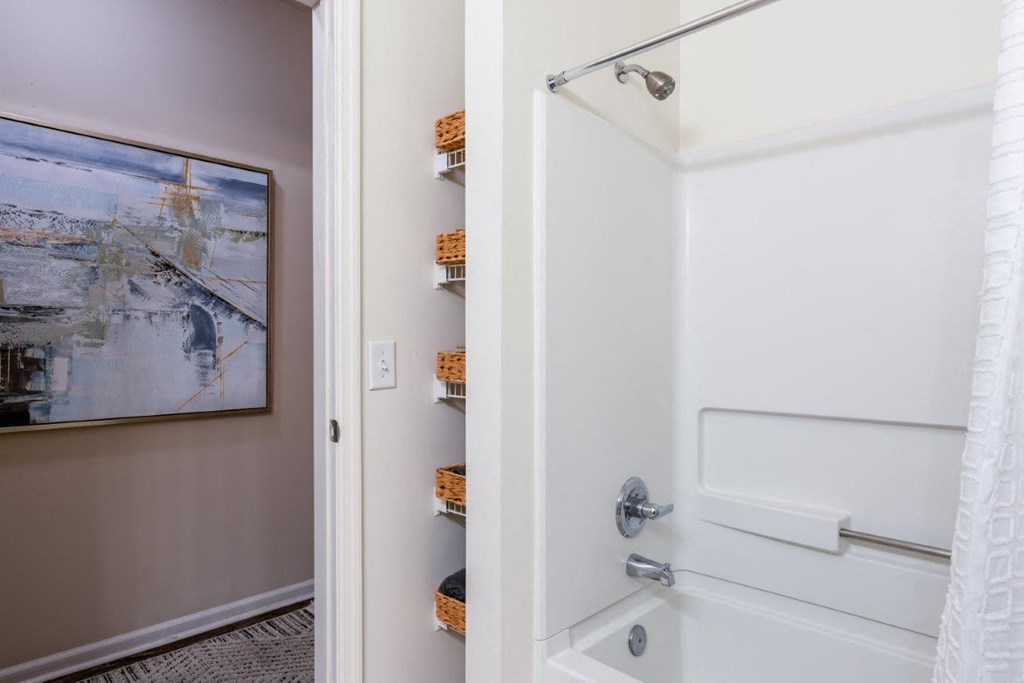 a bathroom with a shower and a door to a closet