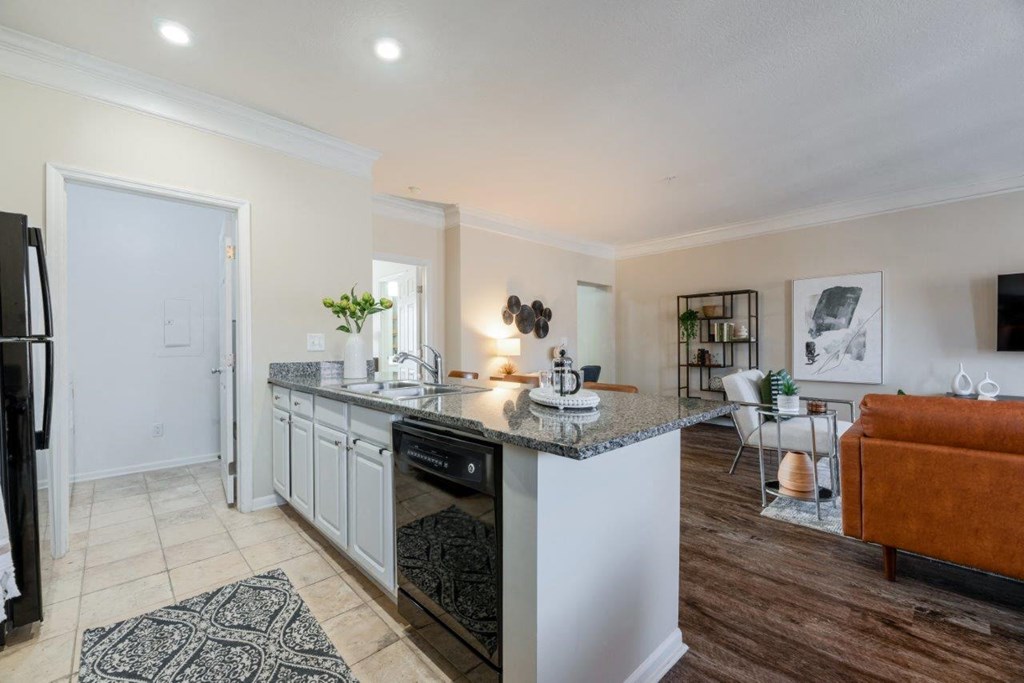 a kitchen with an island and a living room with a couch